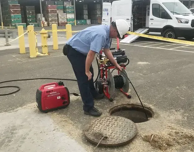 Houston drain technician using professional equipment to clear a blocked sewer line