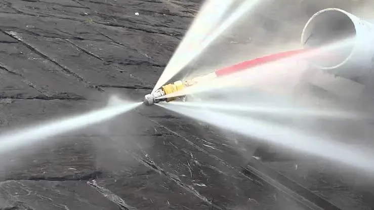 High-pressure hydro jetting nozzle blasting pressurized water streams to scour sewer pipes in Houston, TX 77002